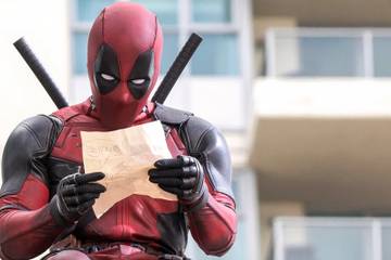 Deadpool holding a piece of paper