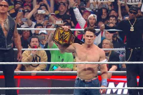 John Cena holding the WWE Championship with The Rock and Travis Scott
