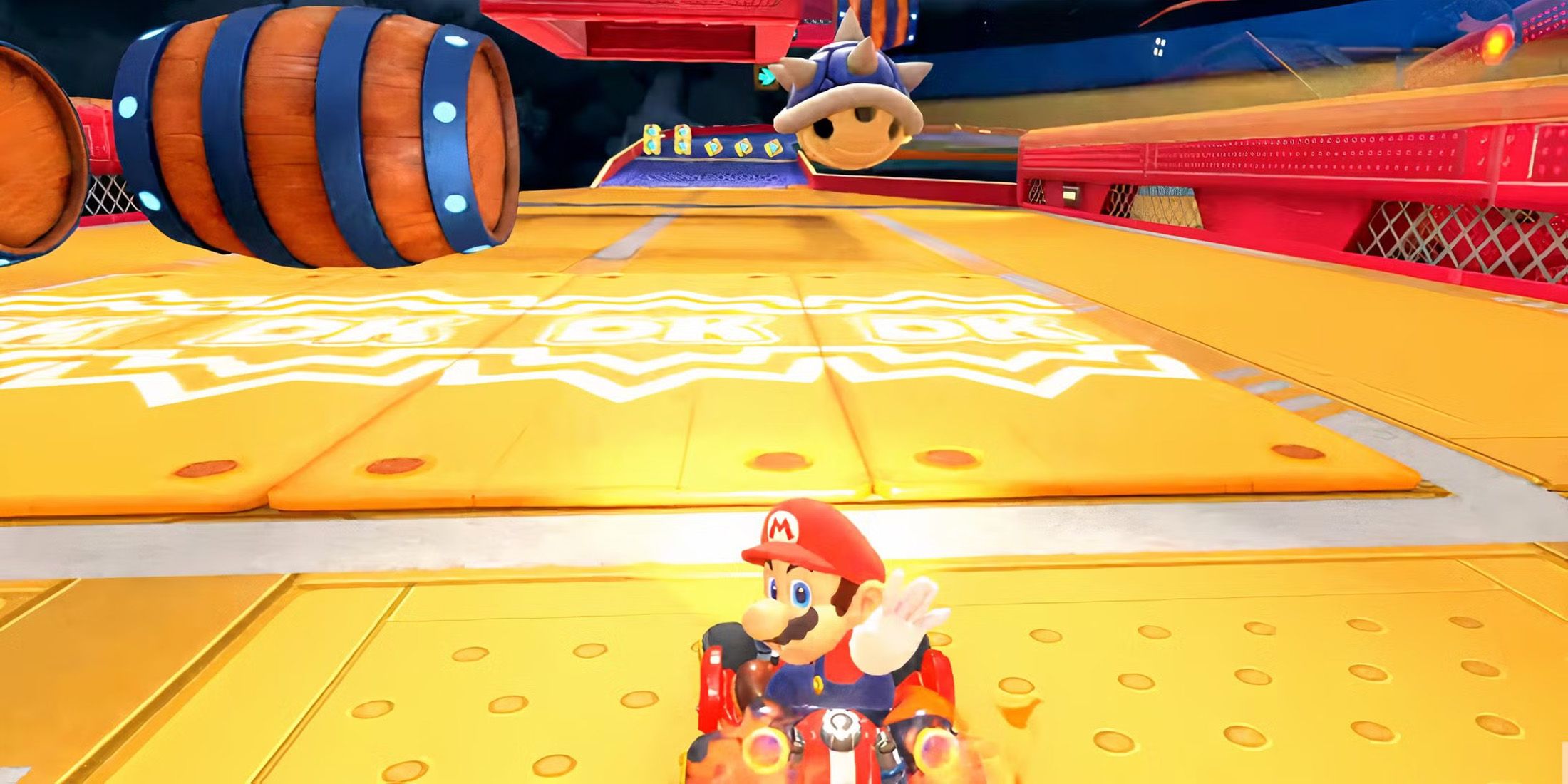 A screenshot of Mario throwing the Blue Shell in Mario Kart World.